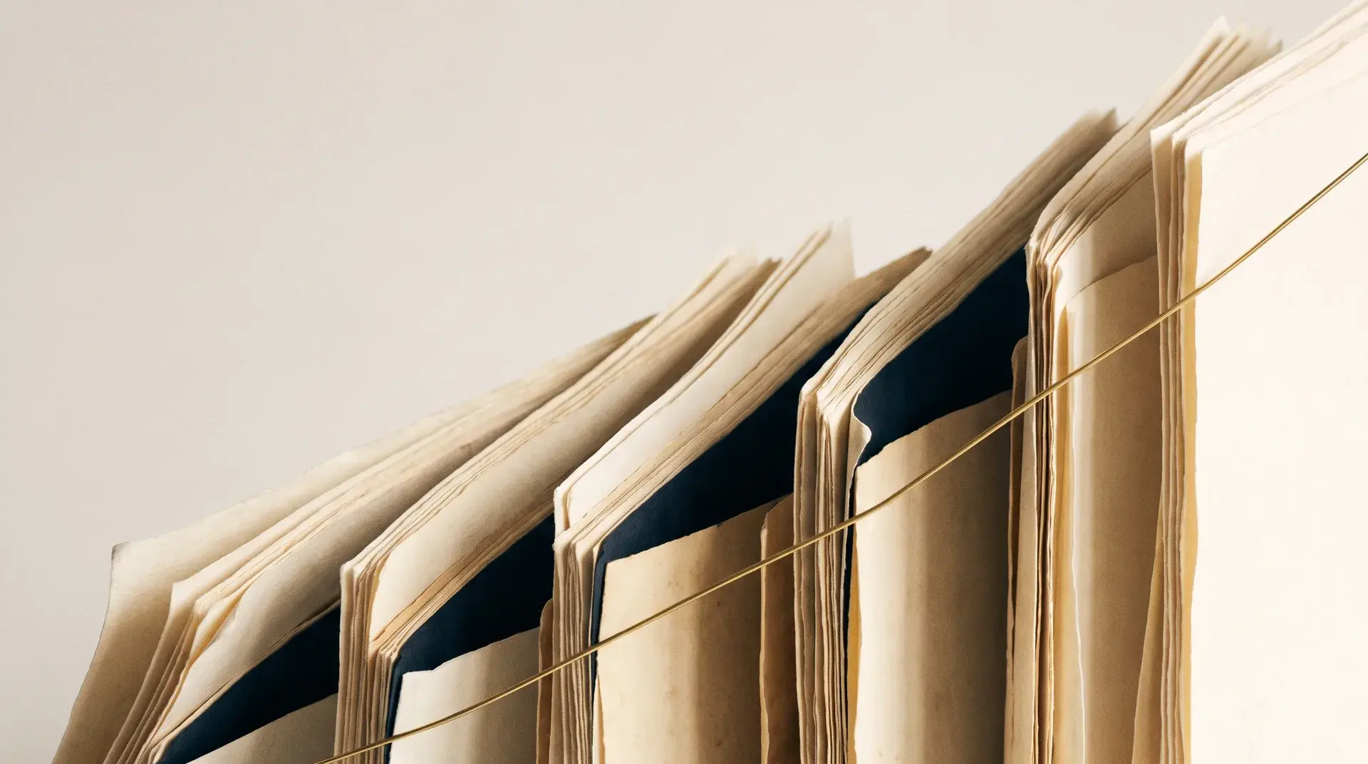 Layered parchment sheets stepping upward like a rising graph, traced by a single brass hairline