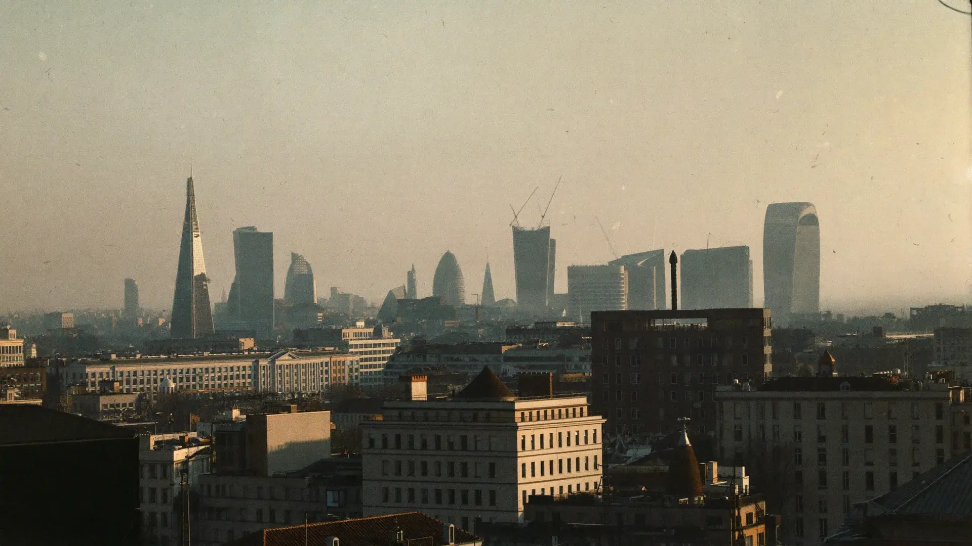 The London skyline at golden hour, seen from a quiet rooftop